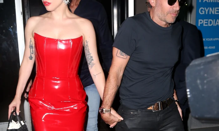 Lady Gaga greets fans on her way out in a red patent leather dress and platform heels jpeg