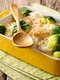 Healthy lunch: rice with broccoli, chicken, garlic and cheese close up in a baking dish on a table  horizontal jpeg