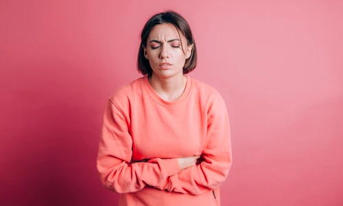 woman wearing casual sweater background suffering stomach ache with painful grimace feeling sudden period cramps gynecology concept jpg