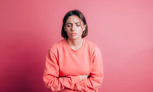 woman wearing casual sweater background suffering stomach ache with painful grimace feeling sudden period cramps gynecology concept jpg