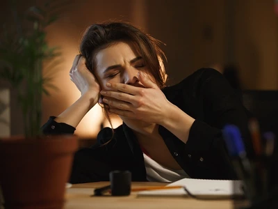 woman yawning office jpg