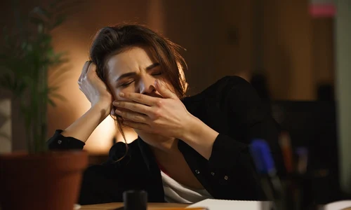 woman yawning office jpg