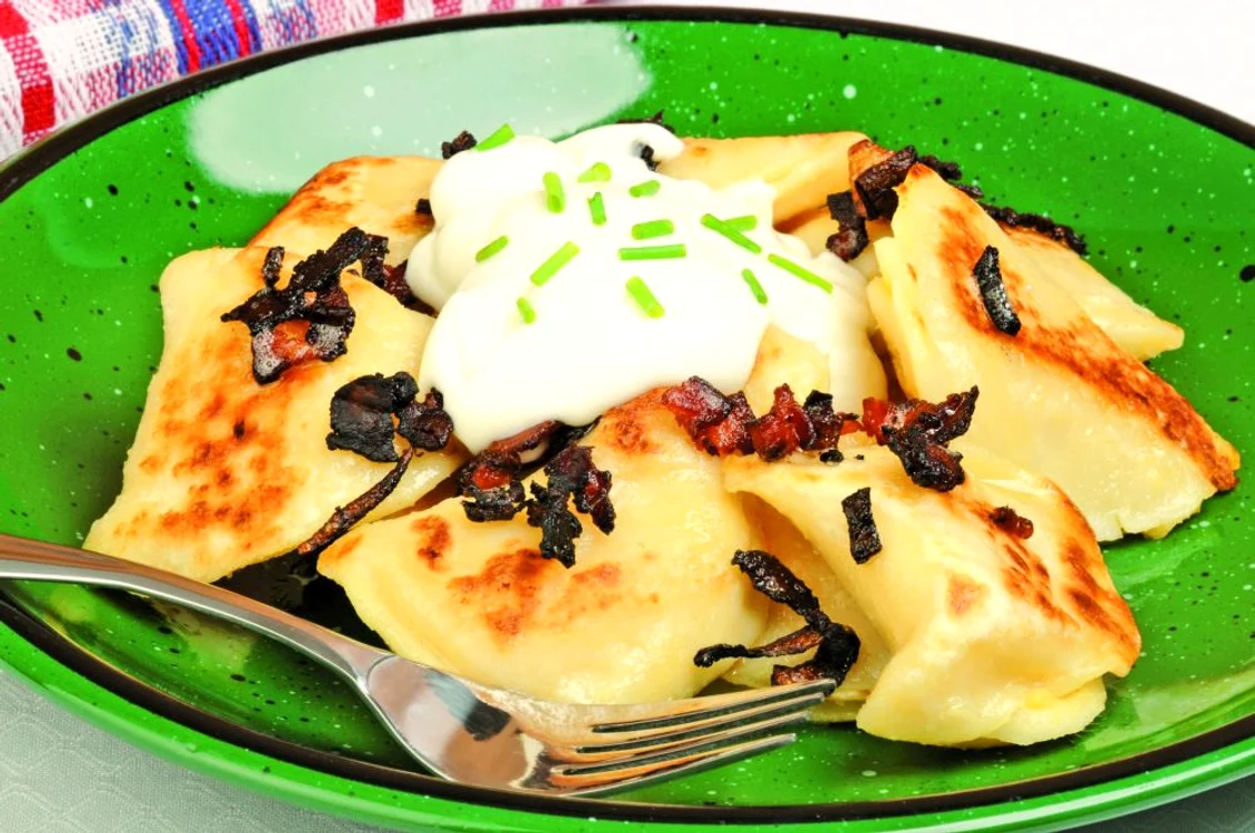 Plate of delicious homemade perogies and sour cream jpeg