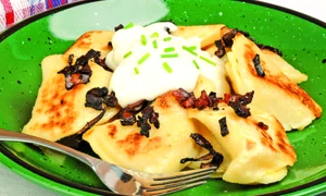 Plate of delicious homemade perogies and sour cream jpeg