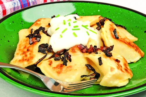 Plate of delicious homemade perogies and sour cream jpeg