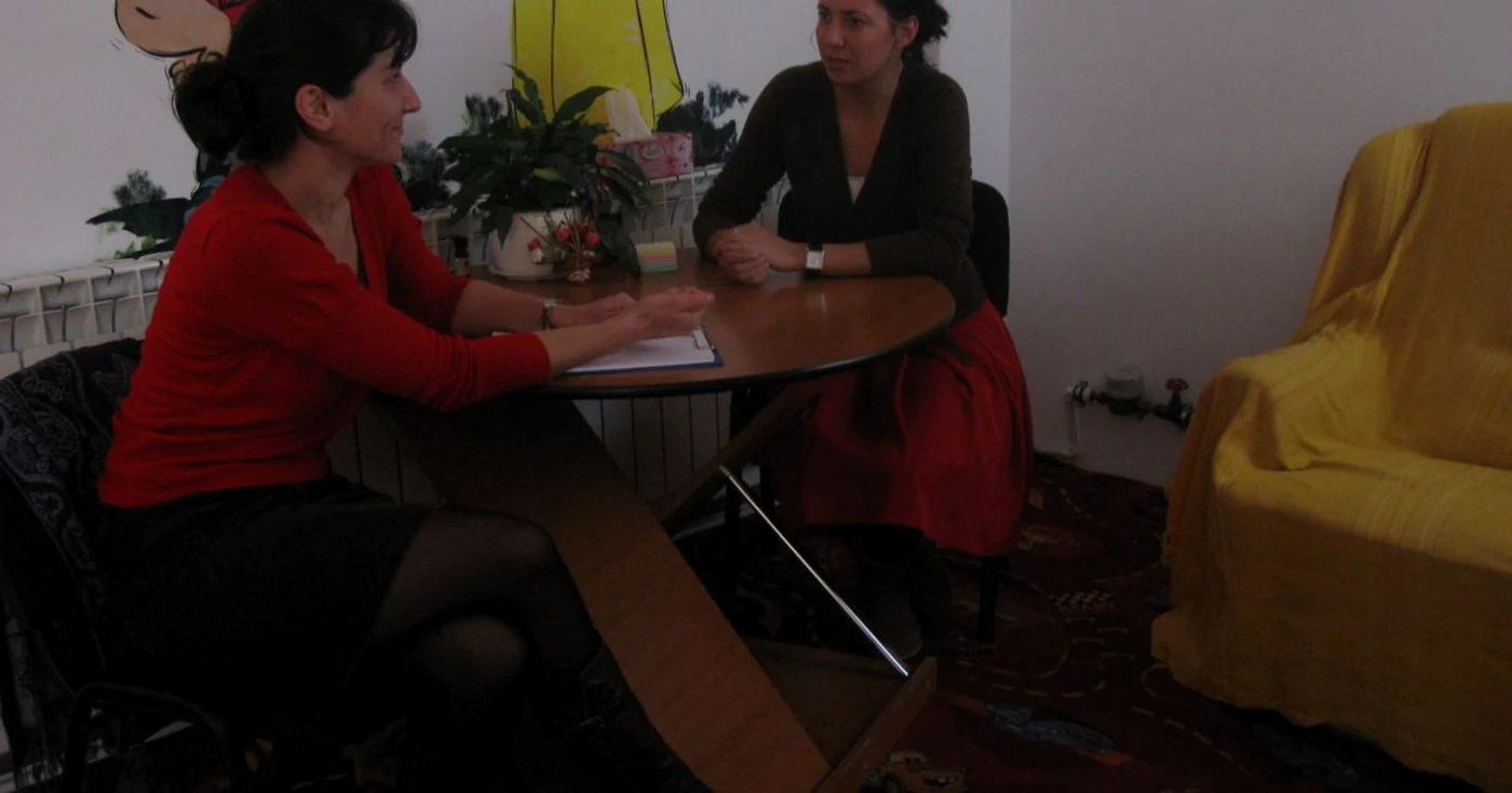 Psihoterapeutul Gicuţa Luca (stânga) notează problemele pe care părinţii le semnalează în relaţia cu cei mici
