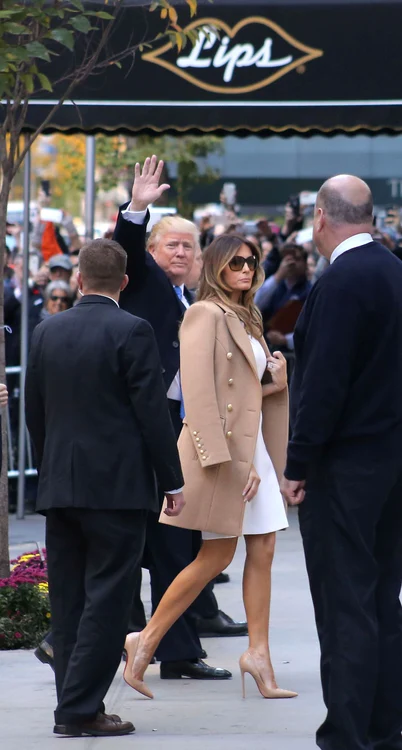 Donald Trump arrives with wife Melania Trump to vote at the polls as he holds her hand and touches her back gently as they arrive with Ivanka and family on Election Day in NYC jpeg