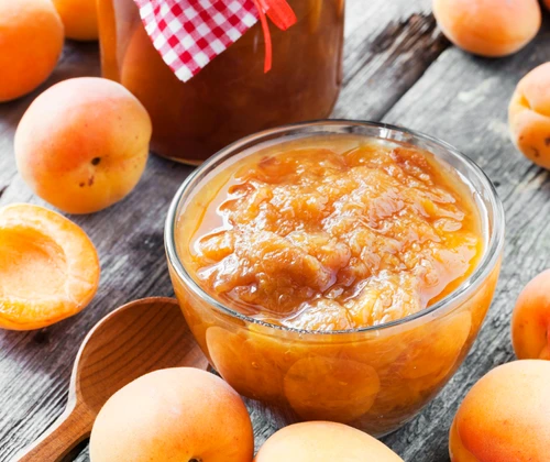 apricot fruits and jar of jam on table jpeg