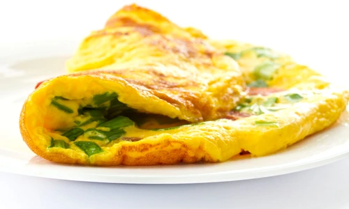 13134807   scrambled eggs with fresh herbs on a white background jpeg