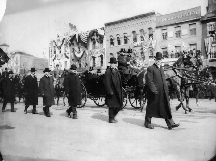 Ofiţerii serviciilor secrete apără caleaşca în care este Theodore Roosevelt. Cea de-a doua învestire a sa,  4 martie 1905.