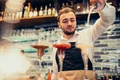 handsome bartender making drinking cocktails counter jpg