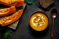 roasted pumpkin carrot soup with cream seeds fresh green ceramic bowl top view jpeg