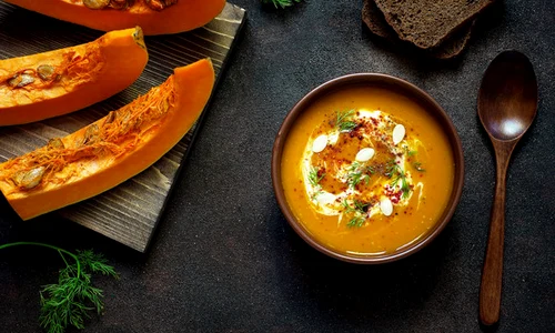 roasted pumpkin carrot soup with cream seeds fresh green ceramic bowl top view jpeg