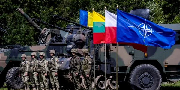 Soldați polonezi și români stau lângă vehicule militare cu steagul NATO Foto AFP jpg