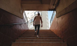 young man climbing stairs pedestrian subway jpg