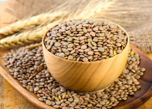 71977337   lentils in a wooden bowl close up on an old table  jpeg