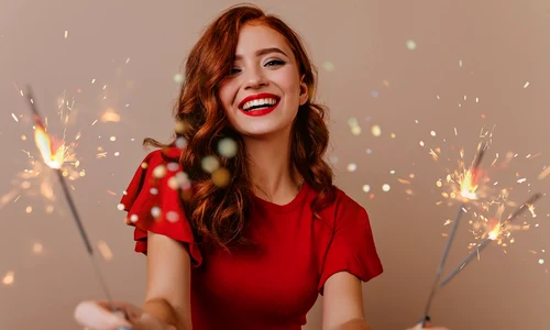 adorable white woman posing with bengal lights gorgeous red haired girl holding sparklers laughing new year jpg
