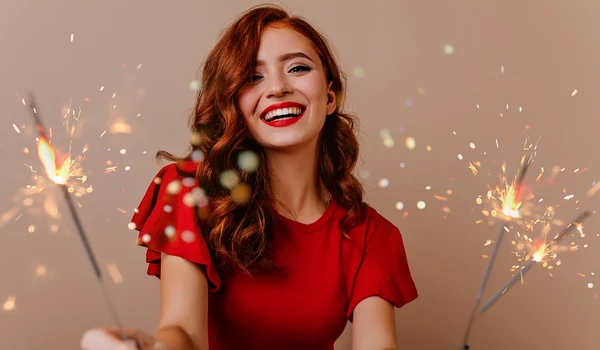 adorable white woman posing with bengal lights gorgeous red haired girl holding sparklers laughing new year jpg