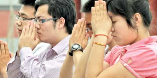 Studenţi care se roagă înainte de începerea examenului