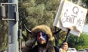 Jake Angeli (Qanon Shaman), seen holding a Qanon sign (cropped) jpg