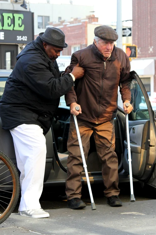 An older looking Robert De Niro sports crutches while filming "The Irishman" with Anna Paquin jpeg