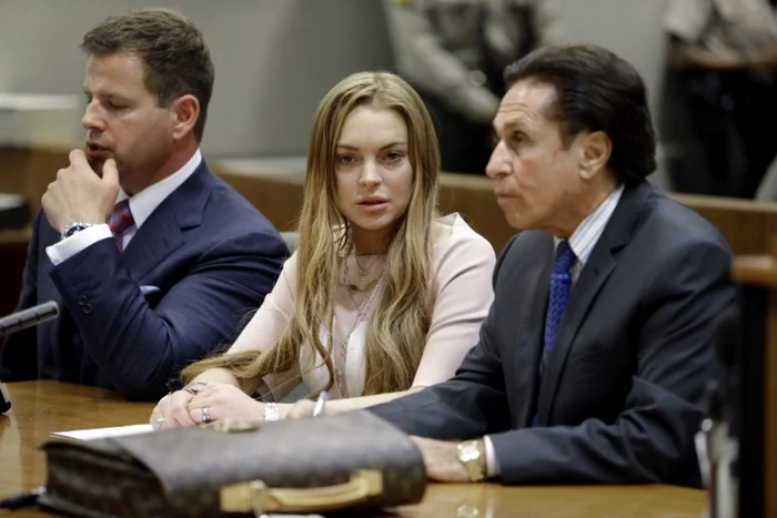 Actriţa Lindsay Lohan şi avocaţii Mark Heller (dreapta) şi Anthony Falangetti (stânga) sunt în Los Angeles la o audiere în faţa Curţii Superioare, pe 18 martie 2013. FOTO AFP