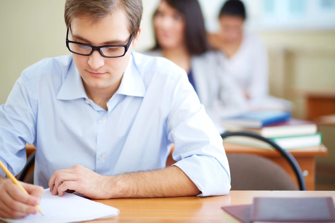 student with glasses writing jpg