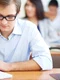 student with glasses writing jpg