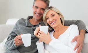 relaxed happy couple with coffee cups in living room 13339 104781 jpeg