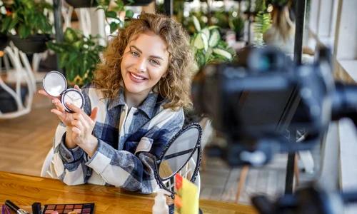 blonde woman blogger is showing how make up use cosmetics jpg