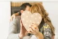 adult couple kissing covering with heart jpg