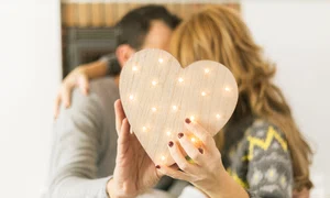 adult couple kissing covering with heart jpg