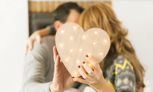 adult couple kissing covering with heart jpg