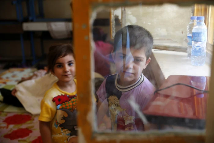 Copiii unei familii creştine care s-a refugiat în Kurdistanul irakian în iunie 2014 Foto Ahmed Jadallah  REUTERS