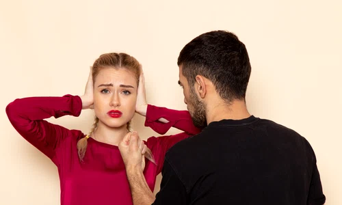 front view young female red shirt suffers from physical threats violence with shut ears cream space female cloth photo jpg