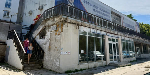 Oameni trec pe lângă un panou cu portretul lui Putin, în Sevastopol, Crimeea 