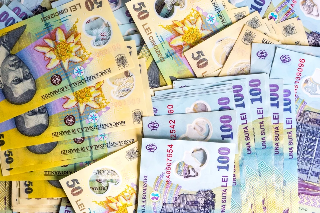 Foarte multe bancnote de 50 și 100 de lei împrăștiate pe o masă