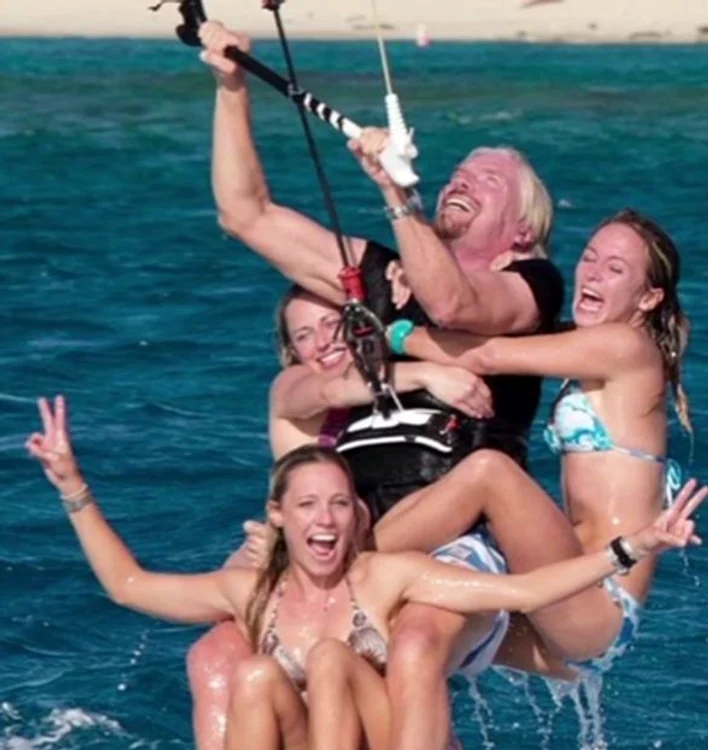 
    Richard Branson şi cele fotomodele care l-au ajutat să doboare recordul.  