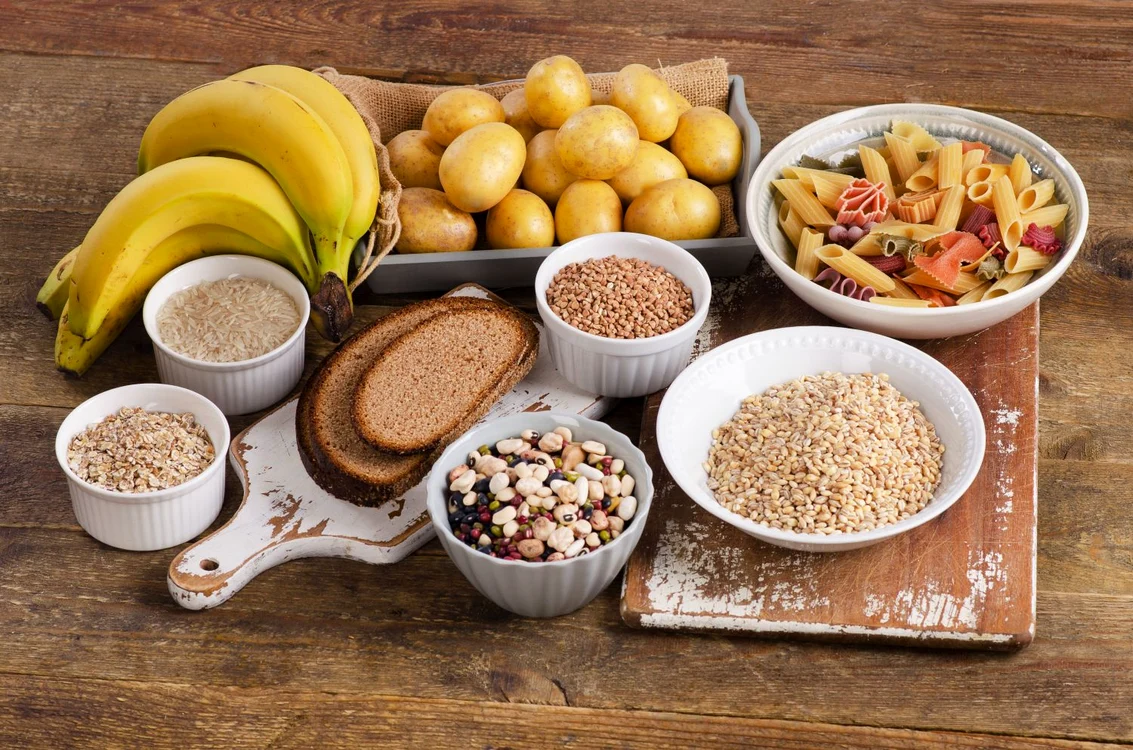 53650552   foods high in carbohydrate on wooden background  top view jpeg