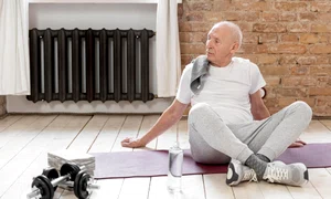 full shot senior man with yoga mat jpg