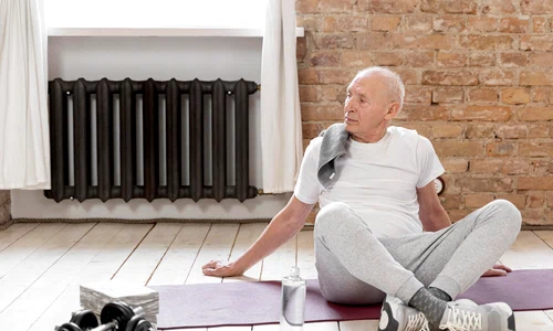 full shot senior man with yoga mat jpg