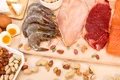 assortment raw protein sources including meat seafood eggs nuts jpg