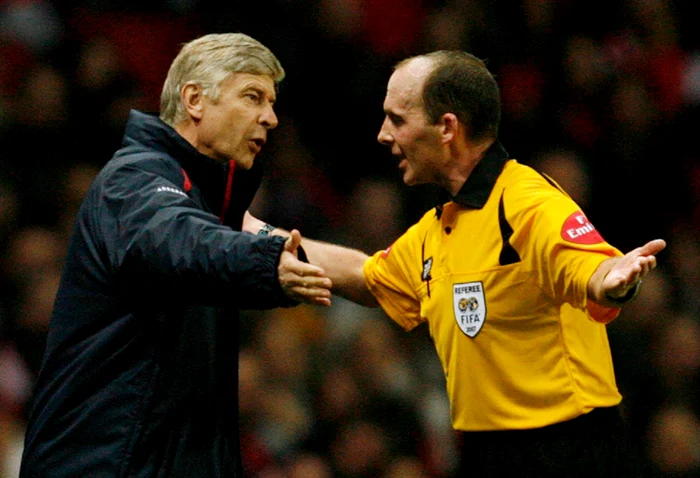 Mike Dean poate fi şi dur, ca în această imagine, în care îl pune la punct pe Arsene Wenger, dar de cele mai multe ori e un adevărat amuzament să-l vezi arbitrândFoto: Reuters