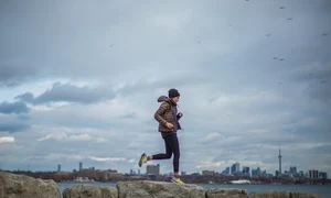 woman standing on stone near body of water 374907 jpeg