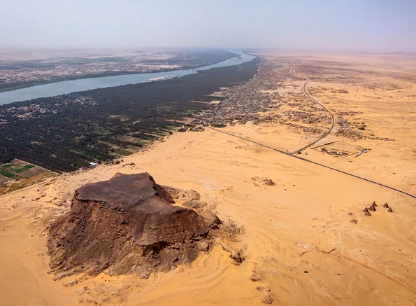 Jebel Barkal (orașul antic Napata), un sit al Patrimoniului Mondial UNESCO din nordul Sudanului, cu Nilul și câmpia sa inundabilă în fundal, privit spre sud-vest (© Sami Elamin (2026), Jebel Barkal Archaeological Project / University of Michigan)