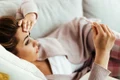 worried woman having high fever while measuring her temperature home copy jpg