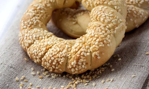 Two homemade bagels with sesame on a gray canvas jpeg
