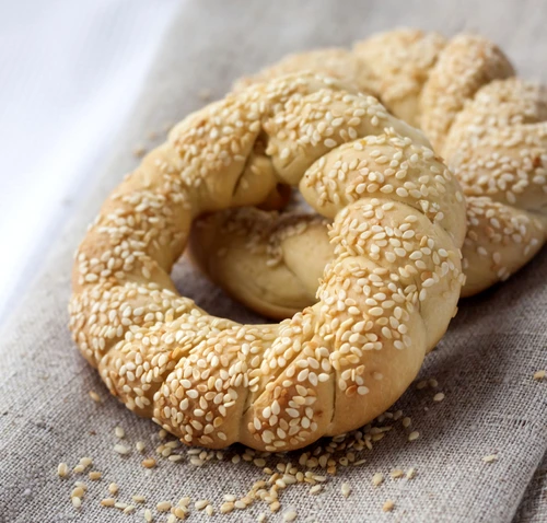 Two homemade bagels with sesame on a gray canvas jpeg