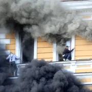 Doi bărbați încearcă să scape din clădirea Academiei Naționale de Științe, cuprinsă de flăcări în urma unui atac cu dronă rusească la Kiev
