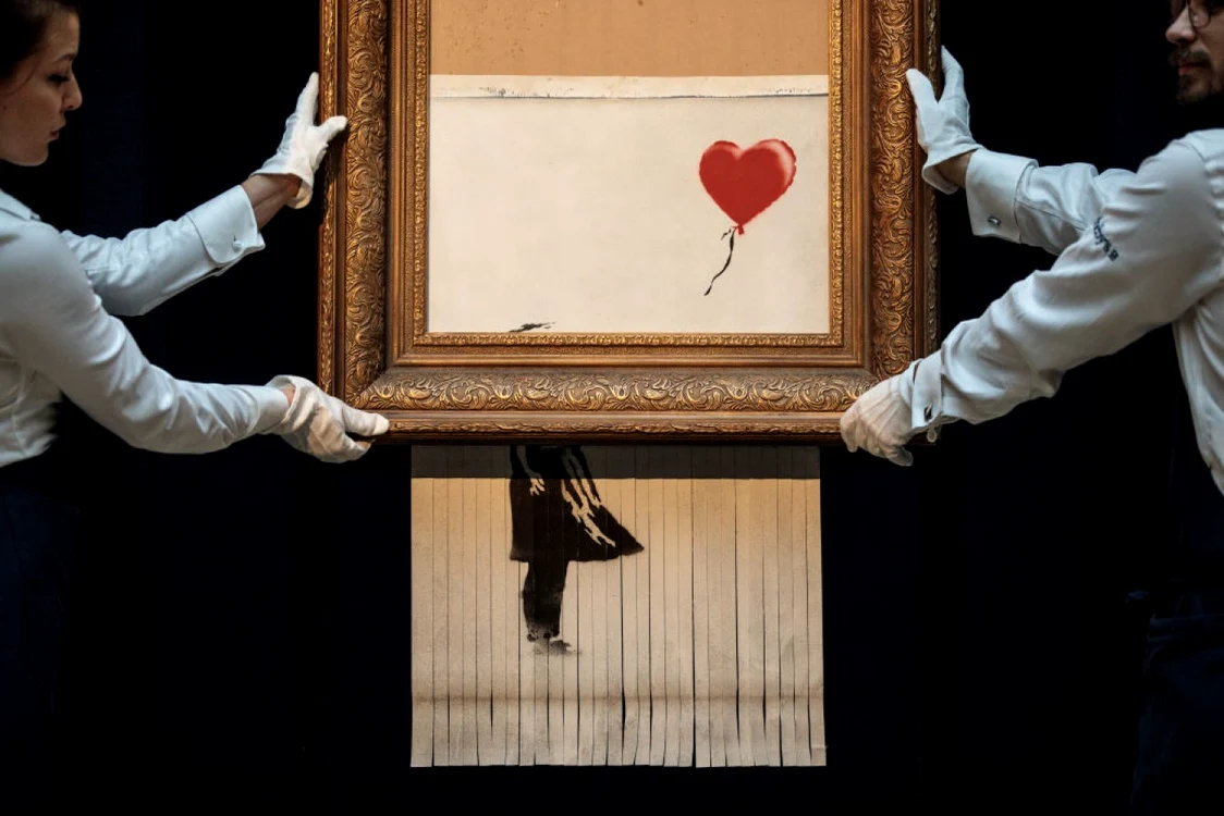 Versiunea din imagine a lucrării "Girl with Ballon" a lui Bansky a fost vândută joi cu 21,8 milioane de euro. FOTO Getty Images